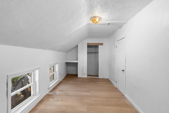 686-688 E Ave, Warwick, RI 02886 - additional living space with a textured ceiling, lofted ceiling, and light wood-style floors