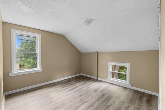 686-688 E Ave, Warwick, RI 02886 - additional living space with healthy amount of natural light, a textured ceiling, wood finished floors, and lofted ceiling
