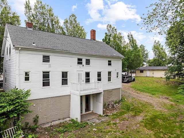 686-688 E Ave, Warwick, RI 02886 - rear view of property featuring a chimney, roof with shingles, and a yard