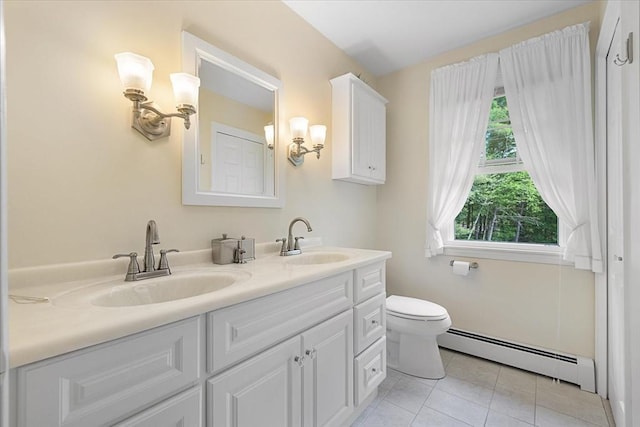 9 Treadwell Ter, Spencer, MA 01562 - full bathroom with baseboard heating, double vanity, tile patterned floors, and toilet