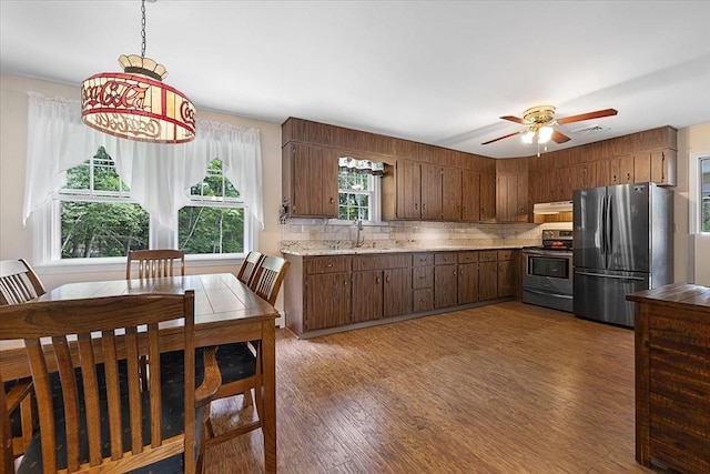 9 Treadwell Ter, Spencer, MA 01562 - kitchen featuring appliances with stainless steel finishes, a sink, light countertops, wood finished floors, and backsplash