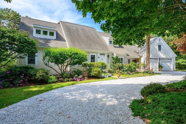 10 Lake Farm Ln, Orleans, MA 02653 - view of front of home with gravel driveway, an attached garage, and a shingled roof