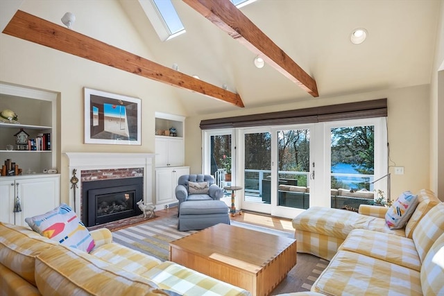10 Lake Farm Ln, Orleans, MA 02653 - living room with a skylight, a fireplace, recessed lighting, built in shelves, and wood finished floors