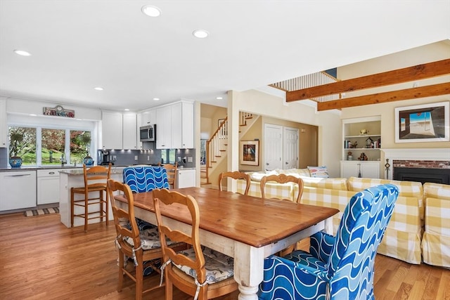 10 Lake Farm Ln, Orleans, MA 02653 - dining space featuring stairs, light wood-style flooring, recessed lighting, beam ceiling, and built in features