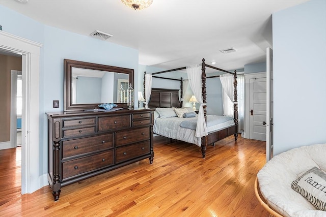 bedroom featuring visible vents and light wood-style floors