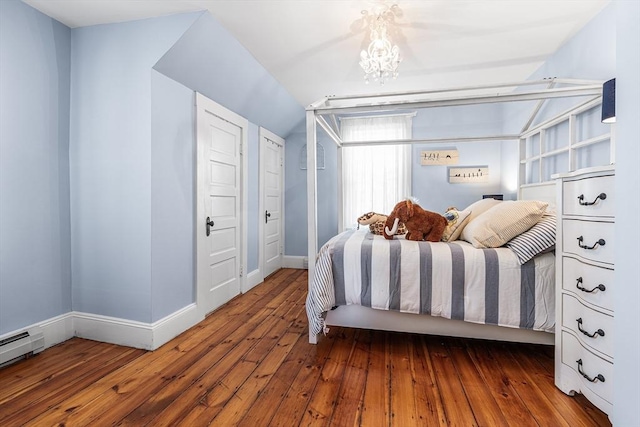 bedroom with vaulted ceiling, baseboards, wood-type flooring, and a baseboard heating unit