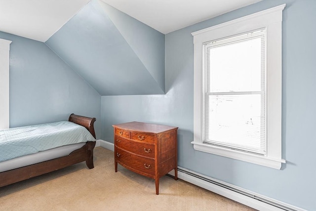 bedroom with light carpet, baseboard heating, and lofted ceiling