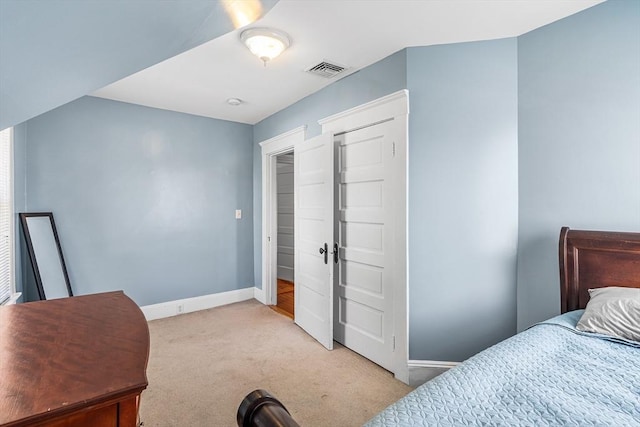 bedroom featuring baseboards, light carpet, and visible vents