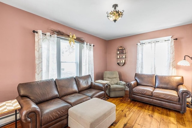 living room featuring a baseboard radiator and light wood-type flooring