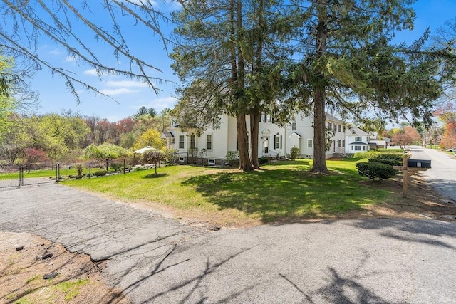 view of property exterior featuring fence and a yard