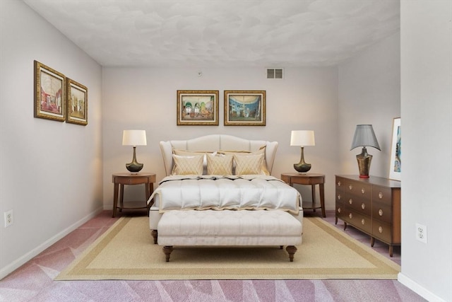 bedroom with visible vents, carpet floors, and baseboards