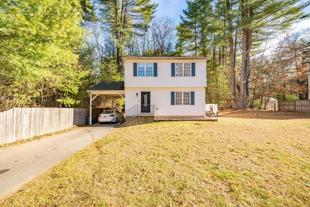 view of front property with a carport and a front yard