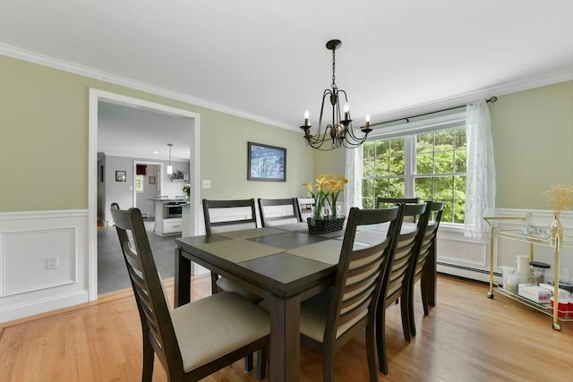186 Mitchell G Dr, Tewksbury, MA 01876 - dining space with a chandelier, ornamental molding, a wainscoted wall, a baseboard heating unit, and wood finished floors