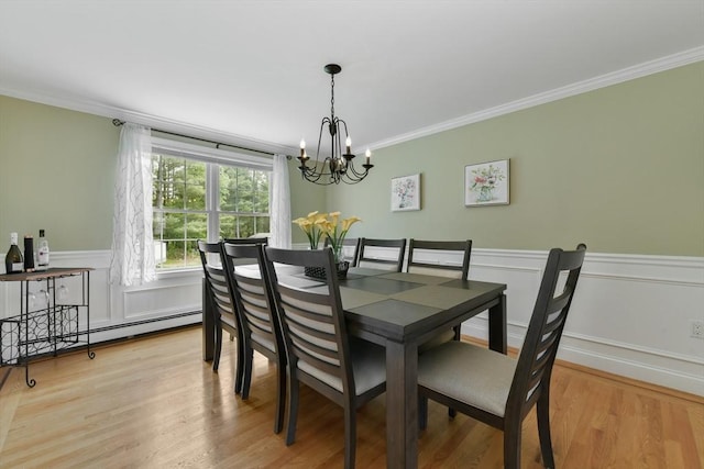 186 Mitchell G Dr, Tewksbury, MA 01876 - dining space featuring a chandelier, ornamental molding, light wood finished floors, a wainscoted wall, and a baseboard heating unit