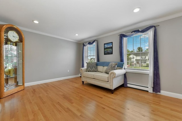 186 Mitchell G Dr, Tewksbury, MA 01876 - living area featuring a baseboard heating unit, light wood finished floors, crown molding, baseboards, and recessed lighting