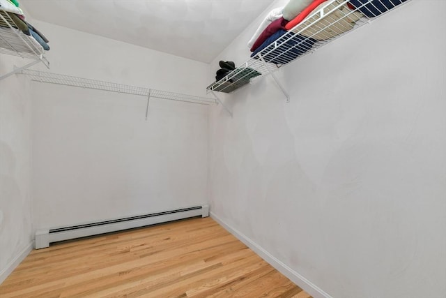 186 Mitchell G Dr, Tewksbury, MA 01876 - walk in closet featuring baseboard heating and wood finished floors