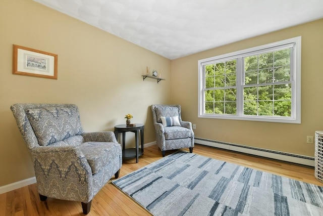 186 Mitchell G Dr, Tewksbury, MA 01876 - living area featuring a baseboard heating unit and wood finished floors