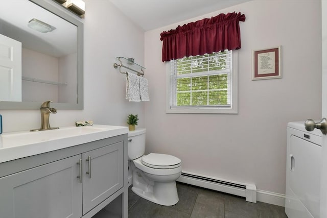 186 Mitchell G Dr, Tewksbury, MA 01876 - half bathroom with baseboard heating, washer / dryer, toilet, vanity, and tile patterned flooring