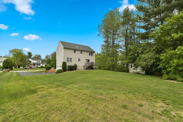 186 Mitchell G Dr, Tewksbury, MA 01876 - view of grassy yard with stairs and asphalt driveway