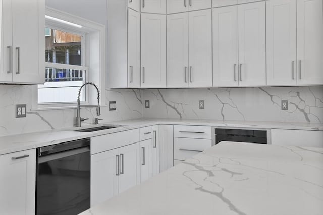 kitchen featuring sink, white cabinetry, tasteful backsplash, light stone counters, and dishwasher