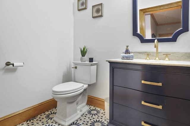 bathroom featuring vanity, tile patterned flooring, and toilet