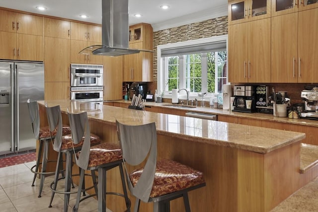 kitchen with sink, a kitchen island, appliances with stainless steel finishes, and island exhaust hood