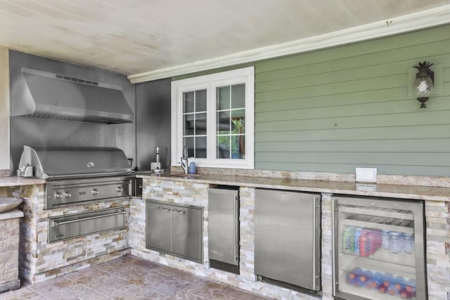 view of patio / terrace with an outdoor kitchen, area for grilling, sink, and wine cooler