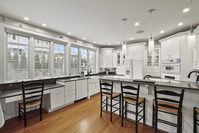 kitchen with white cabinetry, a breakfast bar area, and pendant lighting