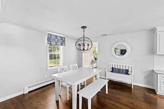 28 Christopher Ln, Scituate, MA 02066 - dining room featuring a baseboard heating unit, a chandelier, and dark wood-style flooring
