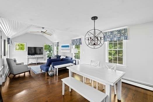 28 Christopher Ln, Scituate, MA 02066 - dining room featuring a chandelier, wood finished floors, lofted ceiling, baseboard heating, and a ceiling fan