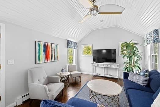 28 Christopher Ln, Scituate, MA 02066 - living room with a baseboard heating unit, a ceiling fan, wood finished floors, and vaulted ceiling