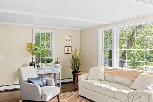 28 Christopher Ln, Scituate, MA 02066 - living room with a baseboard heating unit, healthy amount of natural light, wood finished floors, and ornamental molding