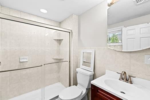 28 Christopher Ln, Scituate, MA 02066 - full bath with a shower stall, vanity, and tile walls