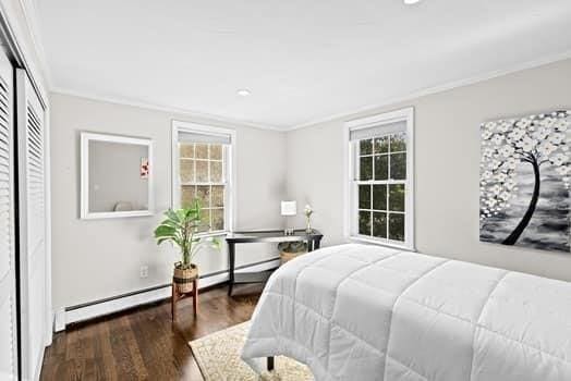 28 Christopher Ln, Scituate, MA 02066 - bedroom with crown molding, wood finished floors, a baseboard radiator, and a closet