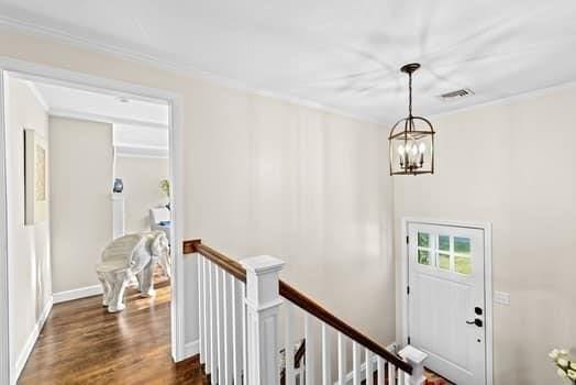 28 Christopher Ln, Scituate, MA 02066 - entrance foyer with a chandelier, crown molding, and dark wood finished floors