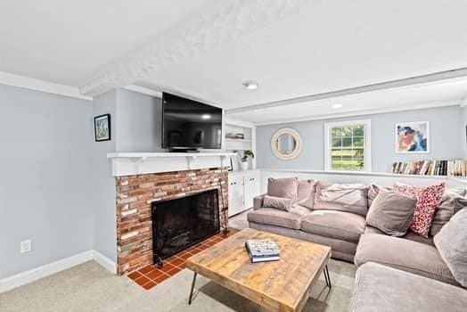 28 Christopher Ln, Scituate, MA 02066 - carpeted living room featuring a fireplace and baseboards