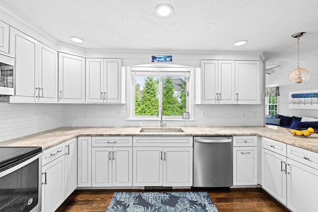 28 Christopher Ln, Scituate, MA 02066 - kitchen with appliances with stainless steel finishes, white cabinets, tasteful backsplash, dark wood-type flooring, and recessed lighting