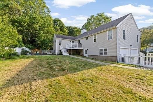 28 Christopher Ln, Scituate, MA 02066 - rear view of house with a garage, stairs, and a wooden deck