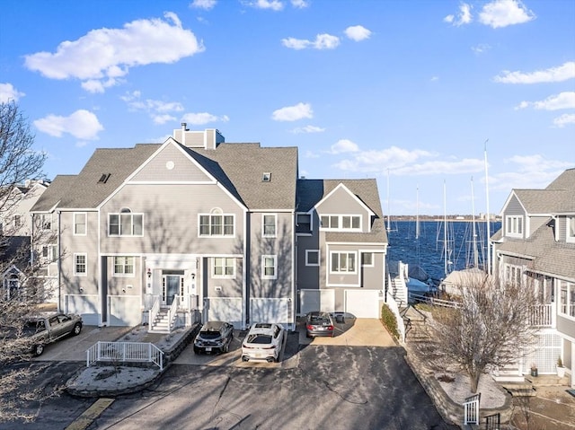 rear view of house featuring a water view