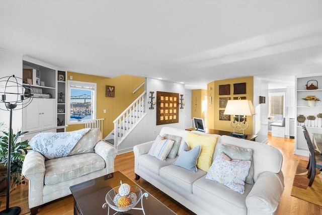 living room with hardwood / wood-style flooring and an inviting chandelier