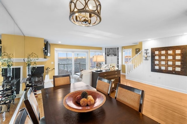 dining area with hardwood / wood-style flooring and a notable chandelier