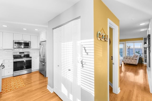 hallway with light hardwood / wood-style flooring