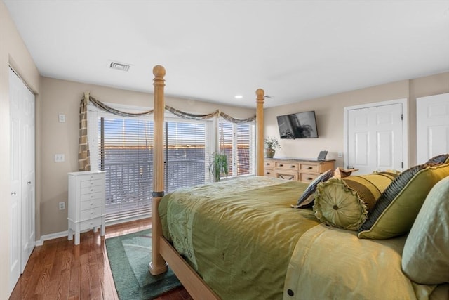 bedroom featuring access to exterior and dark hardwood / wood-style flooring