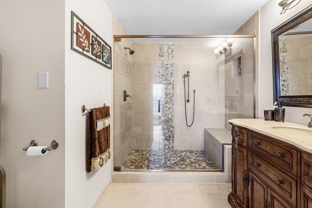 bathroom with tile patterned floors, vanity, and a shower with shower door