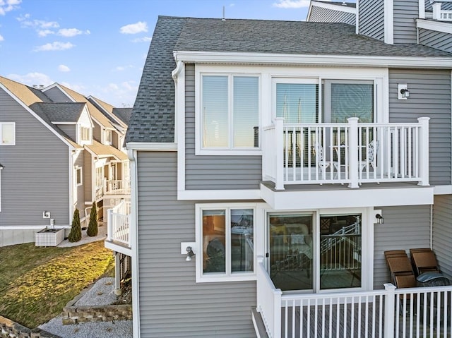 rear view of property with a balcony