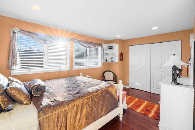 bedroom with a closet and dark hardwood / wood-style flooring