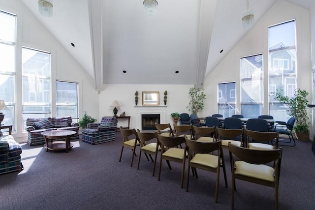 dining area featuring carpet flooring, a towering ceiling, and a healthy amount of sunlight