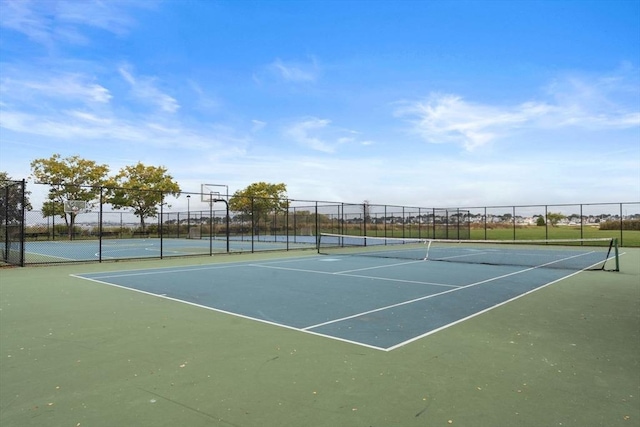 view of tennis court with fence