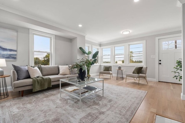 living room with light wood finished floors, baseboards, ornamental molding, and recessed lighting