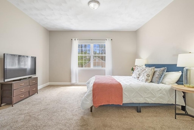 bedroom with baseboards and carpet